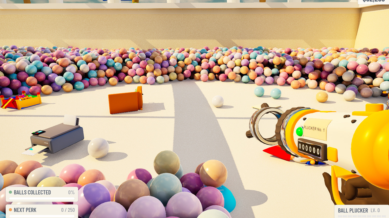 A printer and a toy ball pit uncovered on the cleared floor of the pit, seen past the Ball Plucker.