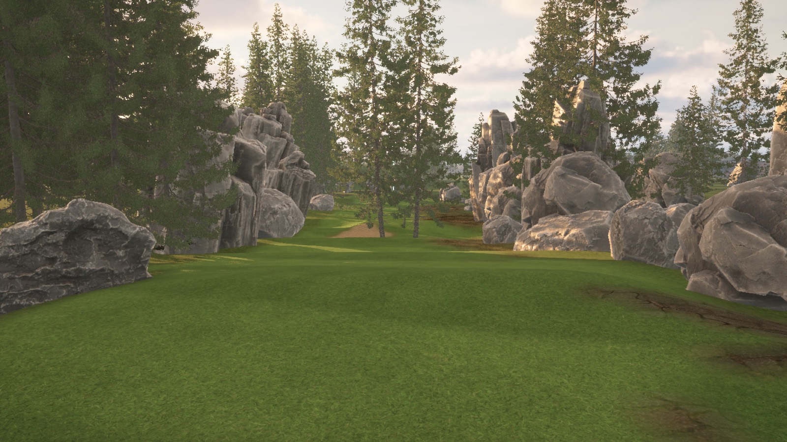 Fairway framed by tall pines and grey boulders leading to a distant green.